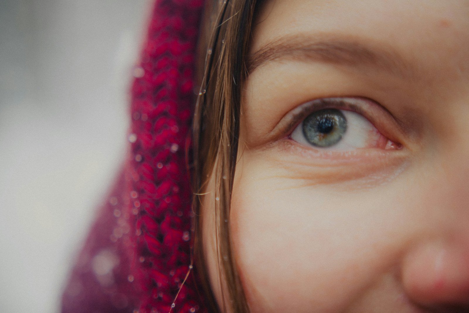 Close-up of a young girl's eye, black pupil and pale iris
