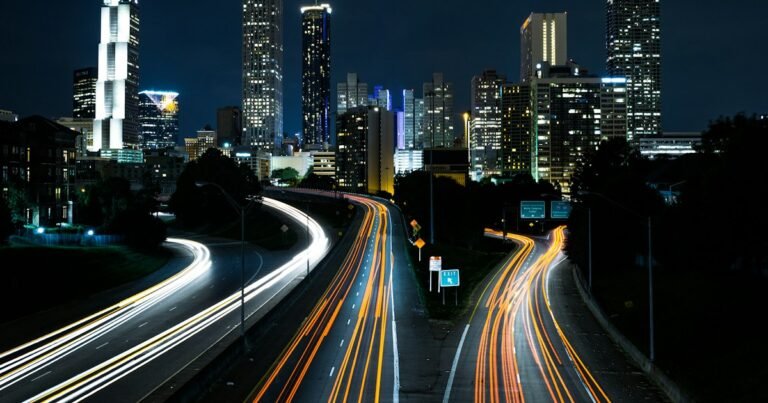 Light trails from cars on a city highway at night