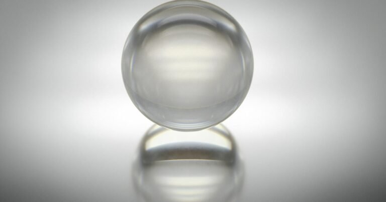 Clear glass sphere on a white surface