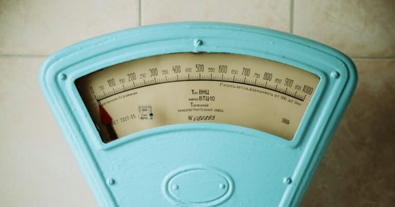 Vintage turquoise weighing scale on a tiled wall