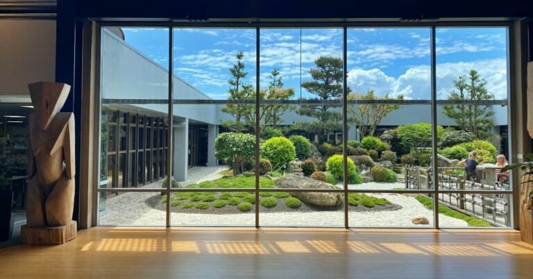 Large glass wall looking out onto a Japanese garden