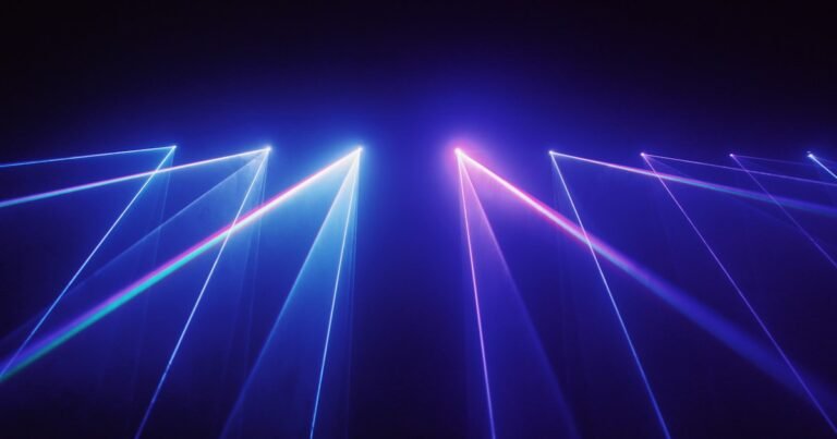 Blue and violet laser beams against a dark background
