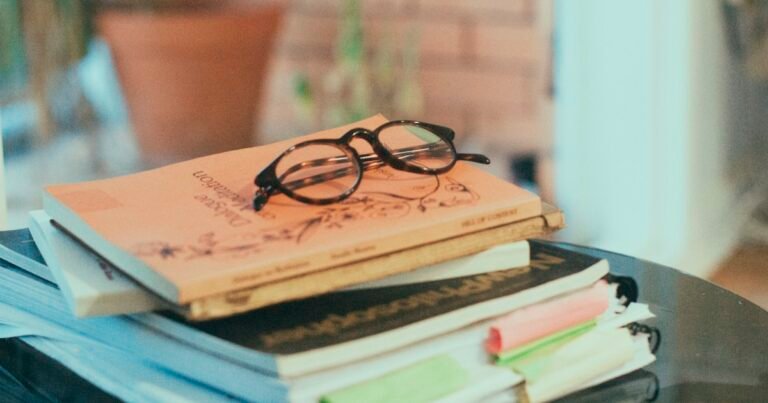 Glasses resting on a stack of books