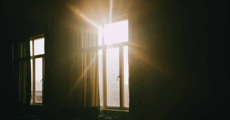 Sunlight streaming through a window into a dark room