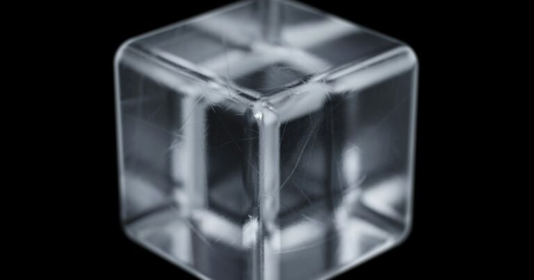 Clear ice cube on a black background
